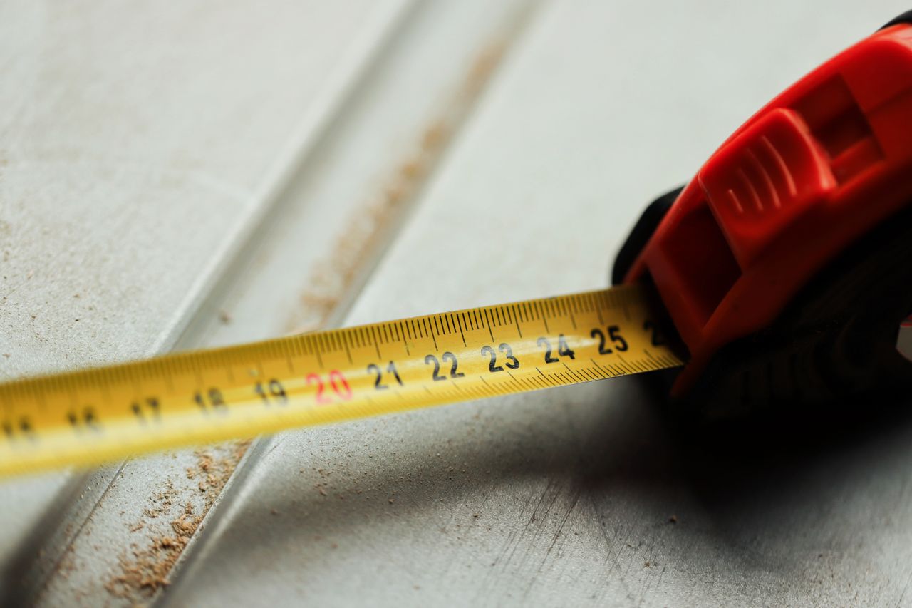 Photograph of a person's hand holding a tape measure