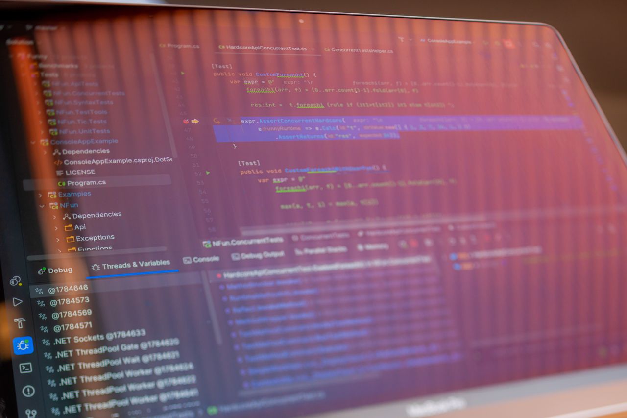 Photograph of a laptop screen showing software source code