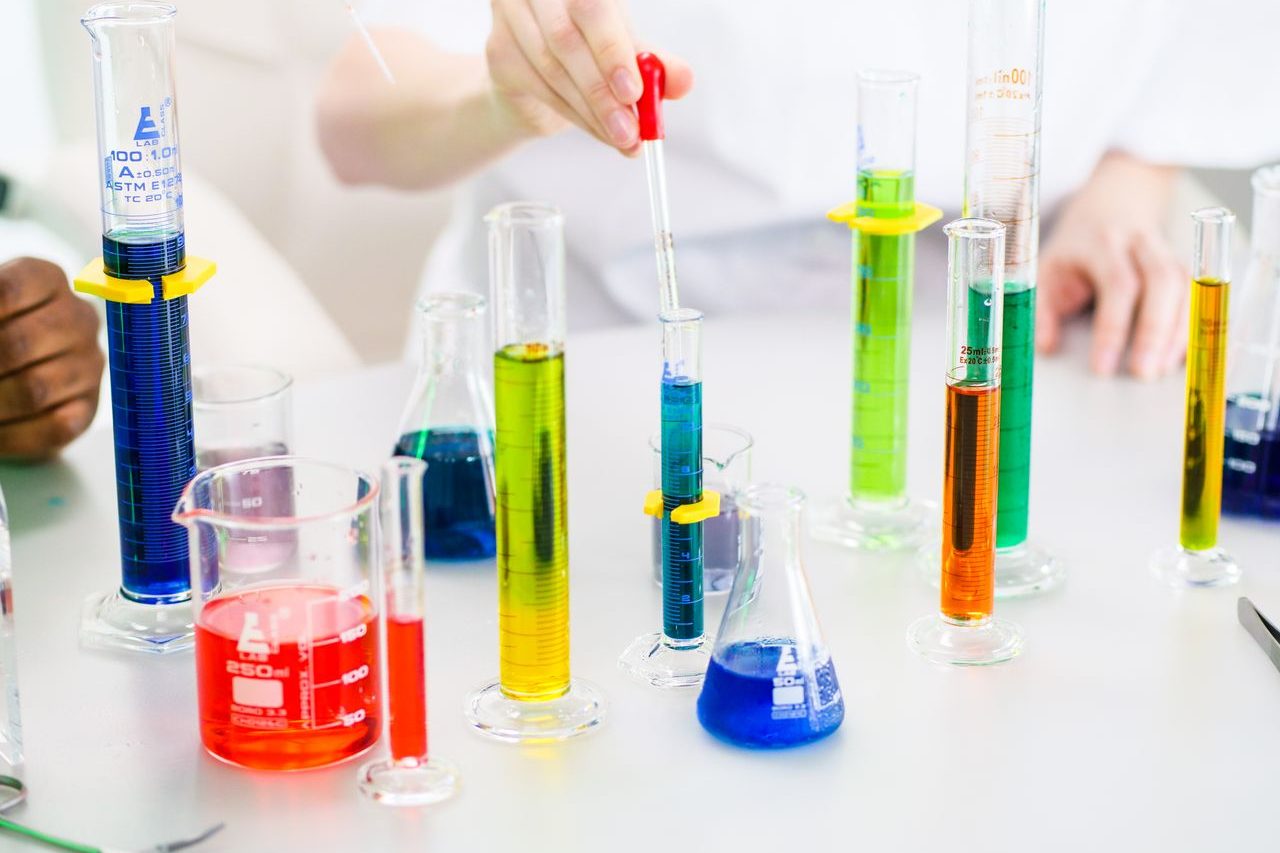 Photograph showing a series of test tubes filled with varying colours of liquid