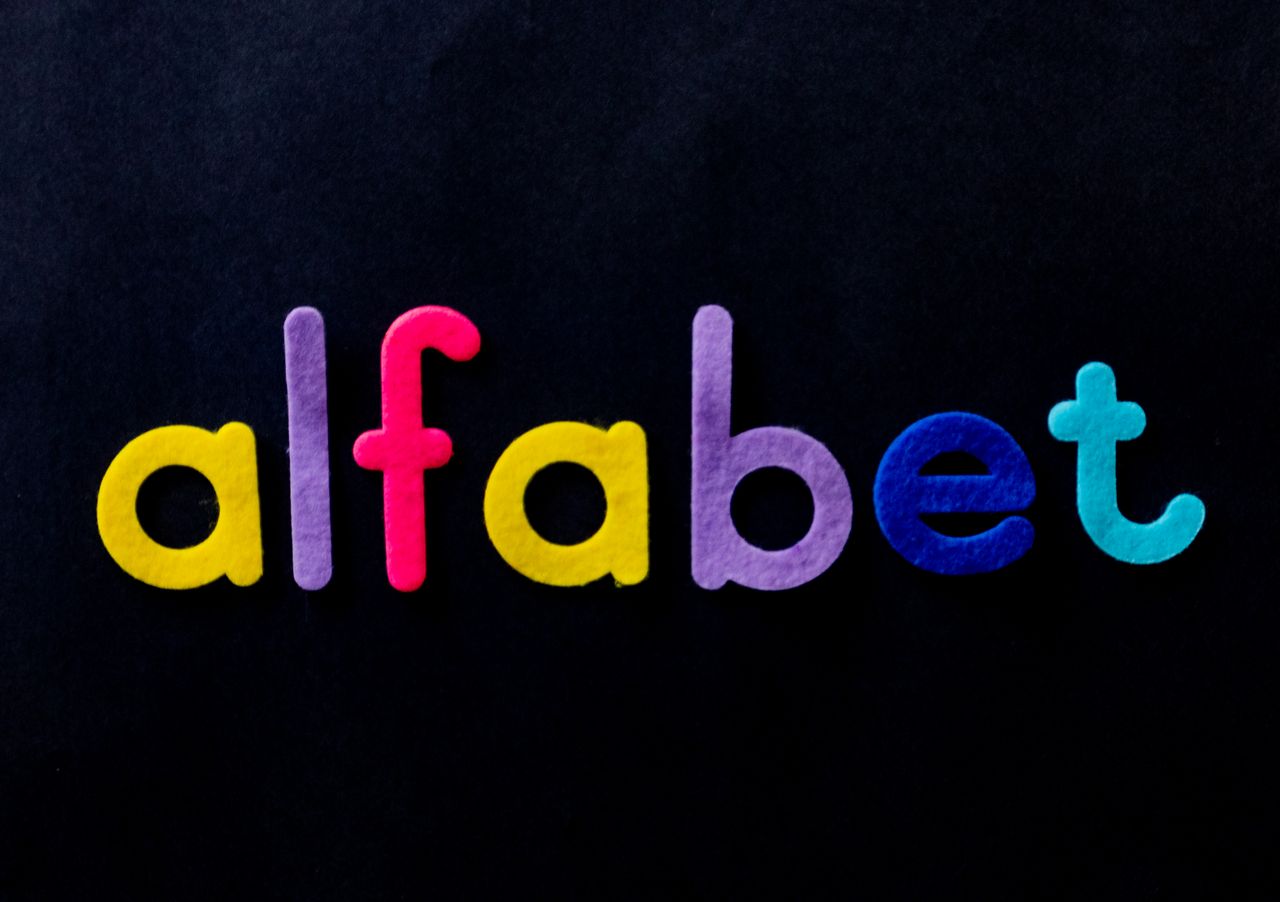 A photograph showing letters in different colours showing the word alfabet spelt incorrectly