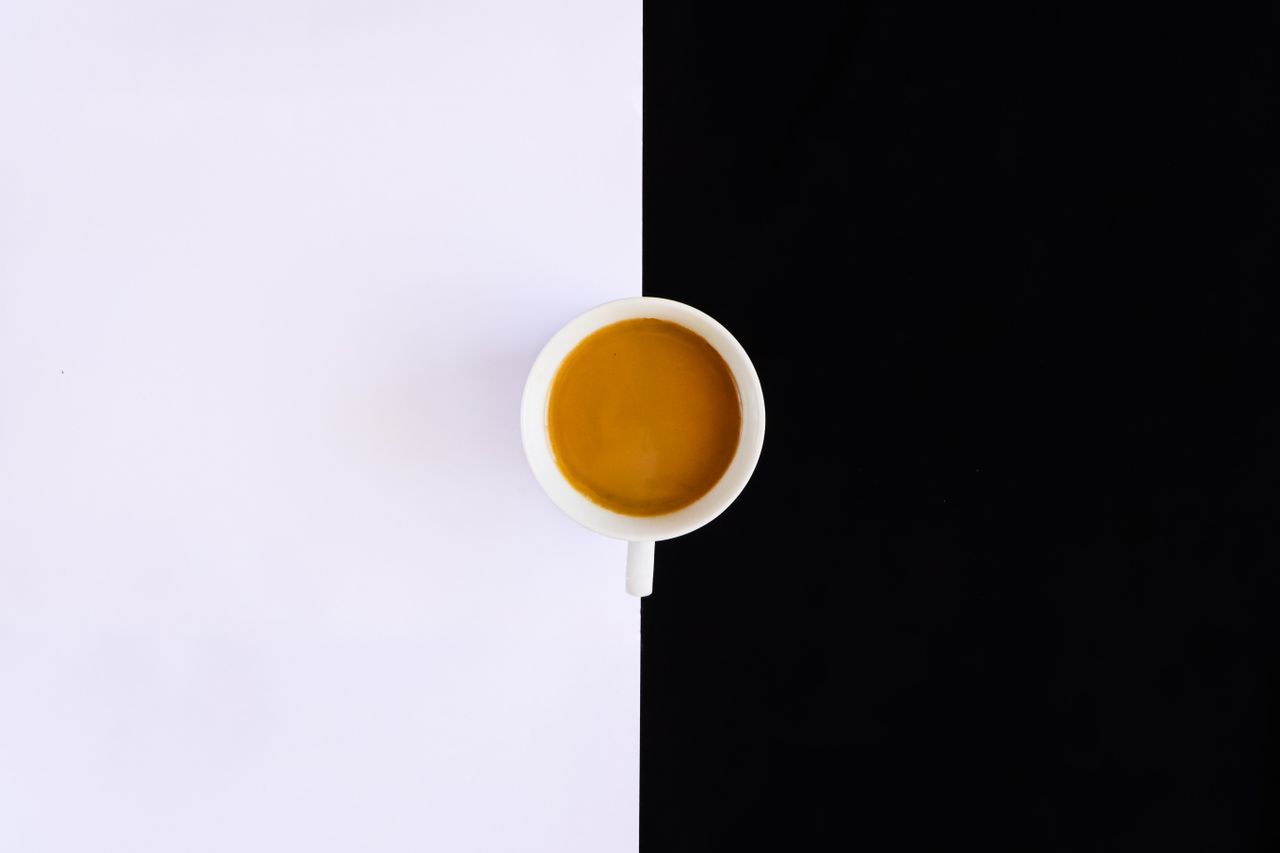 A decorative illustration including black and white with an orange circle in the centre demonstrating contrast ratio